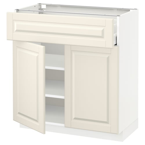 An off-white METOD kitchen cabinet with bevelled edges, featuring two open doors and a drawer.
