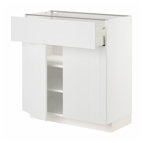A white METOD kitchen cabinet with a drawer and two open shelves, featuring a modern, sleek design with quality materials.