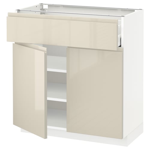 A white and beige kitchen cabinet with high gloss and integrated handles. It a drawer and open shelves.