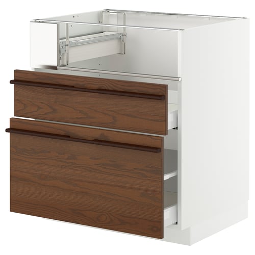 Notched wooden drawer fronts on white cabinet, metallic top.