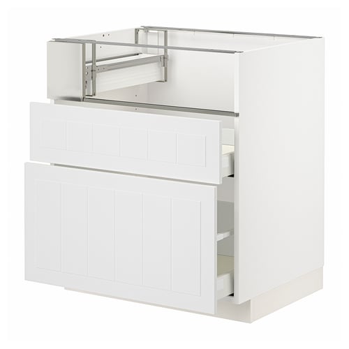 White METOD kitchen cabinet with wood panel design and pull-out drawers.