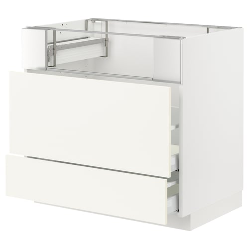 A white METOD kitchen cabinet with two drawers and a pull-out shelf. It a modern, minimalist design with sleek lines and a glossy finish.