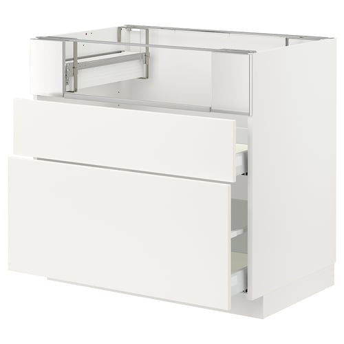 Modern white kitchen cabinet with drawers and metal hardware.