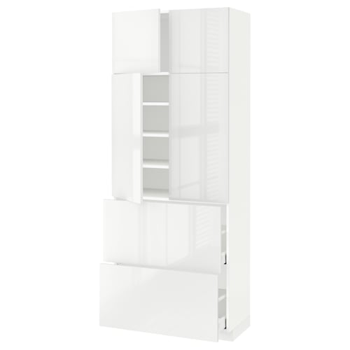 A white high-gloss METOD kitchen cabinet with adjustable shelves and a soft-closing drawer.