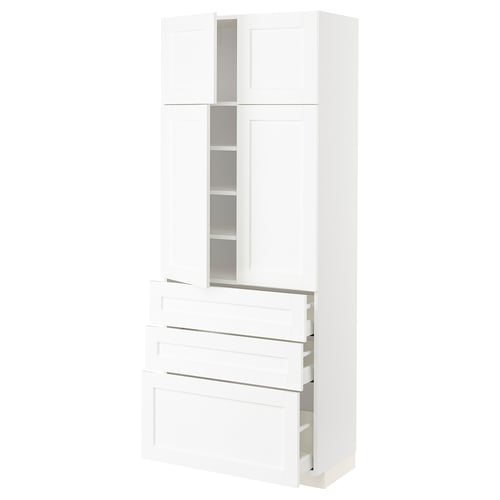 A white METOD kitchen cabinet with a modern design featuring multiple shelves and drawers.