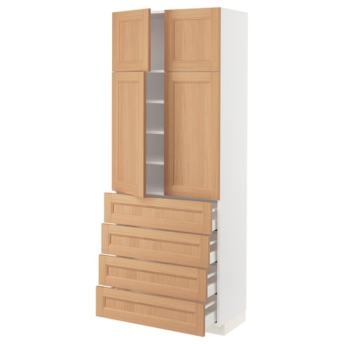 The ikea METOD kitchen cabinet with oak doors and drawers. Its tall, white, and four wooden drawers and two cabinet doors.