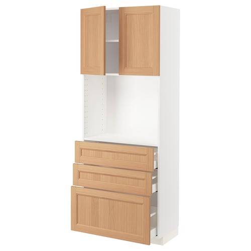 An ikea METOD kitchen cabinet in white, with light oak drawers and doors. It includes two open shelves, three drawers, and two cabinet doors.