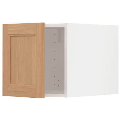 Oak cabinet door open, reveal hinges. Framed, natural wood tone, simple design.