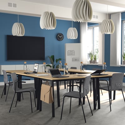 Modern MITTZON conference table with grey chairs, white pendant lights, and blue walls. Large, rectangular, and versatile design ideal for meetings.