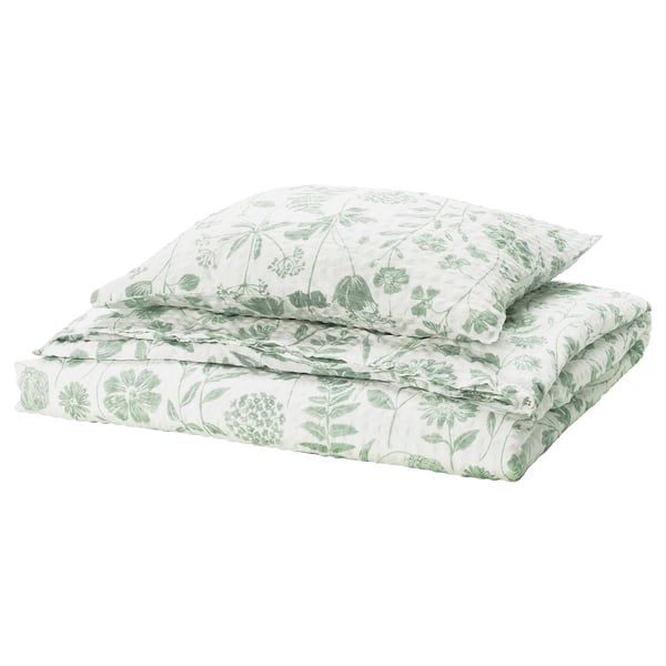 Folded green floral bedding set, green flowers on white, cotton-viscose blend with seersucker texture.