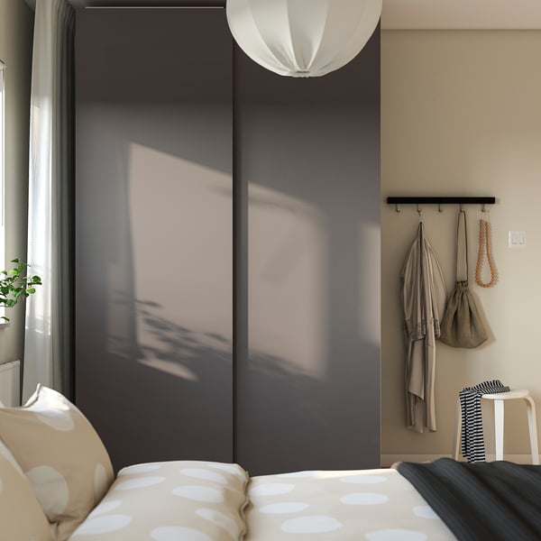 Modern bedroom with PAX wardrobe, pendant light, polka-dot bed.