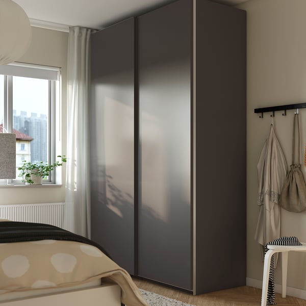 Black PAX wardrobe near window, modern storage.