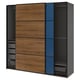 Modern PAX wardrobe with wooden, blue, and grey sliding doors. Shelves and drawers.
