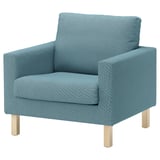 A blue SALTSJÖBADEN armchair with wooden legs made of recycled polyester and cotton.