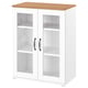 A white SKRUVBY storage cabinet. The top is light wood. It has glass doors with metal handles, displaying empty shelves inside.