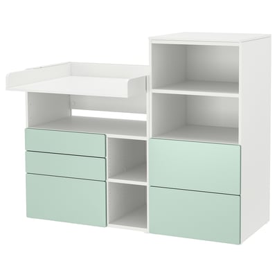 Small white and light green changing table and storage unit with drawers and shelves. Modern and practical.