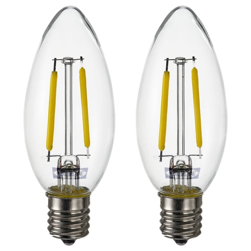 Two identical bulbs side by side. Clear glass with yellow led coils. E12 base. Rounded teardrop shape. No text.