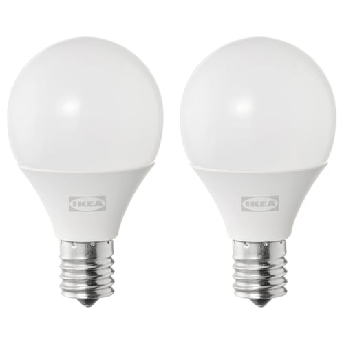 Two ikea white spherical led light bulbs with metallic base.