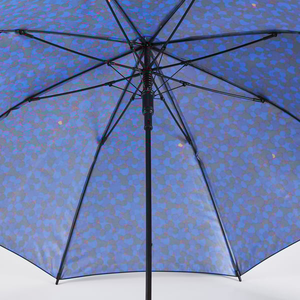Open umbrella with blue, grey, and red pattern; sturdy black frame, recycled fabric.