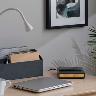 Minimalist workspace with STENGRÖNSKA alarm clock, laptop, organiser, mug, plant, and lamp.