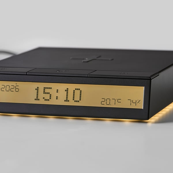 Modern digital alarm clock with temp/humidity, wireless charging, led lights, sleek recycled body, clear screen.