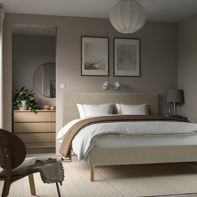 Modern bedroom with TÄRNKULLEN bed, white linens, abstract art, wooden dresser, grey throw, pendant & lamp.