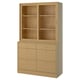 Wooden storage unit with mix of drawers and glass cabinets, light oak finish.
