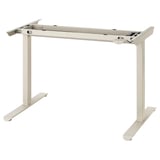 A beige TRAVSPORT adjustable desk frame. Its made of steel and plastic, designed for height adjustment, and has a rectangular base.