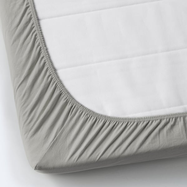 A fitted sheet in grey colour made of cotton, featuring elastic edges for a secure fit.