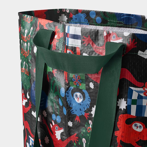Large reusable bag with colourful, festive pattern, sturdy handles, perfect for shopping.