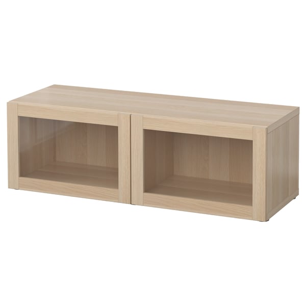 Light wooden BESTÅ storage unit, rectangular shape with open compartments, light finish.