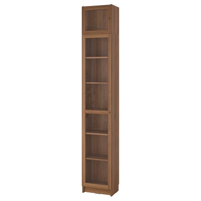 A tall BILLY bookcase in a warm brown colour, featuring multiple adjustable shelves and a wooden finish.