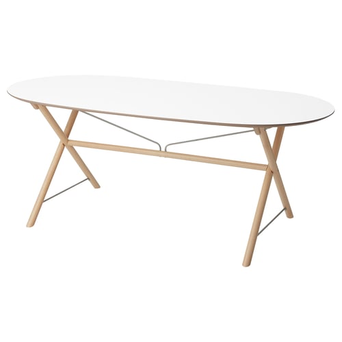 The DALSHULT table a clear glass top, light wood legs, and stainless steel supports.