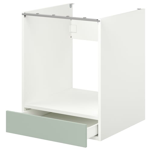 A white ENHET cabinet with built-in oven space and light green drawer for efficient storage.
