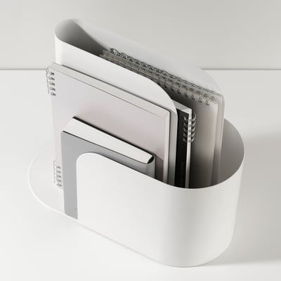 White magazine holder with 3 compartments, storing notebooks and a book, organising desk items.