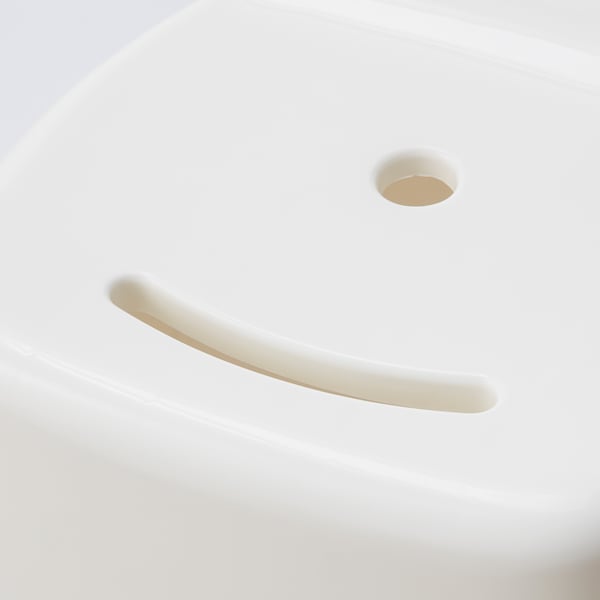 A modern, minimalist stool with smooth curves and a drain hole, showcasing high-quality plastic design.