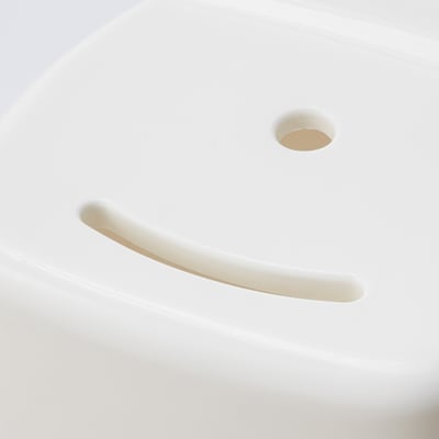 A modern, minimalist stool with smooth curves and a drain hole, showcasing high-quality plastic design.