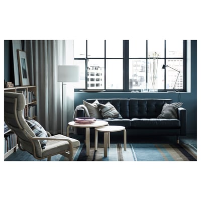 Black leather sofa, modern design, tufted cushions, wooden legs.