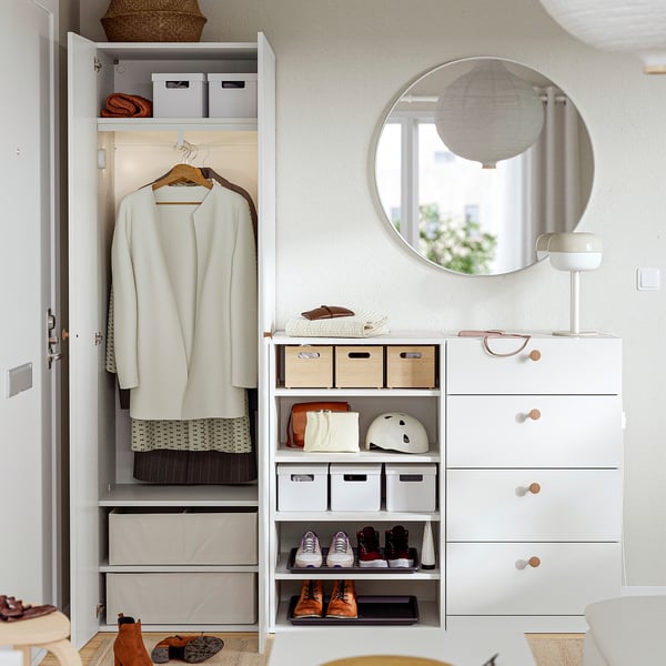 A well-organized closet with adjustable feet, holding clothes and storage bins, reflecting a neat and tidy space.