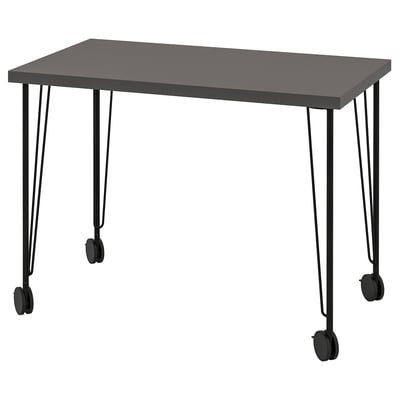 A LINNMON desk, black, rectangular, with a smooth surface on hairpin legs with castors.