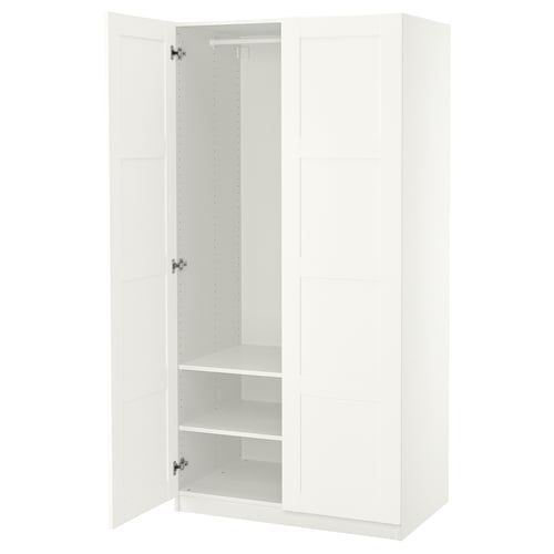 White PAX wardrobe, open, featuring adjustable feet and interior shelves for organisation.