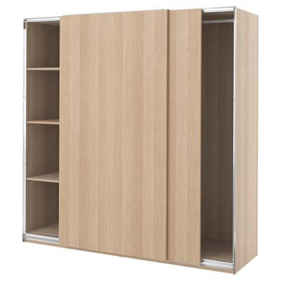 A PAX wardrobe with light beige sliding doors and a particleboard frame. Its rectangular with three sections, designed for efficient storage.
