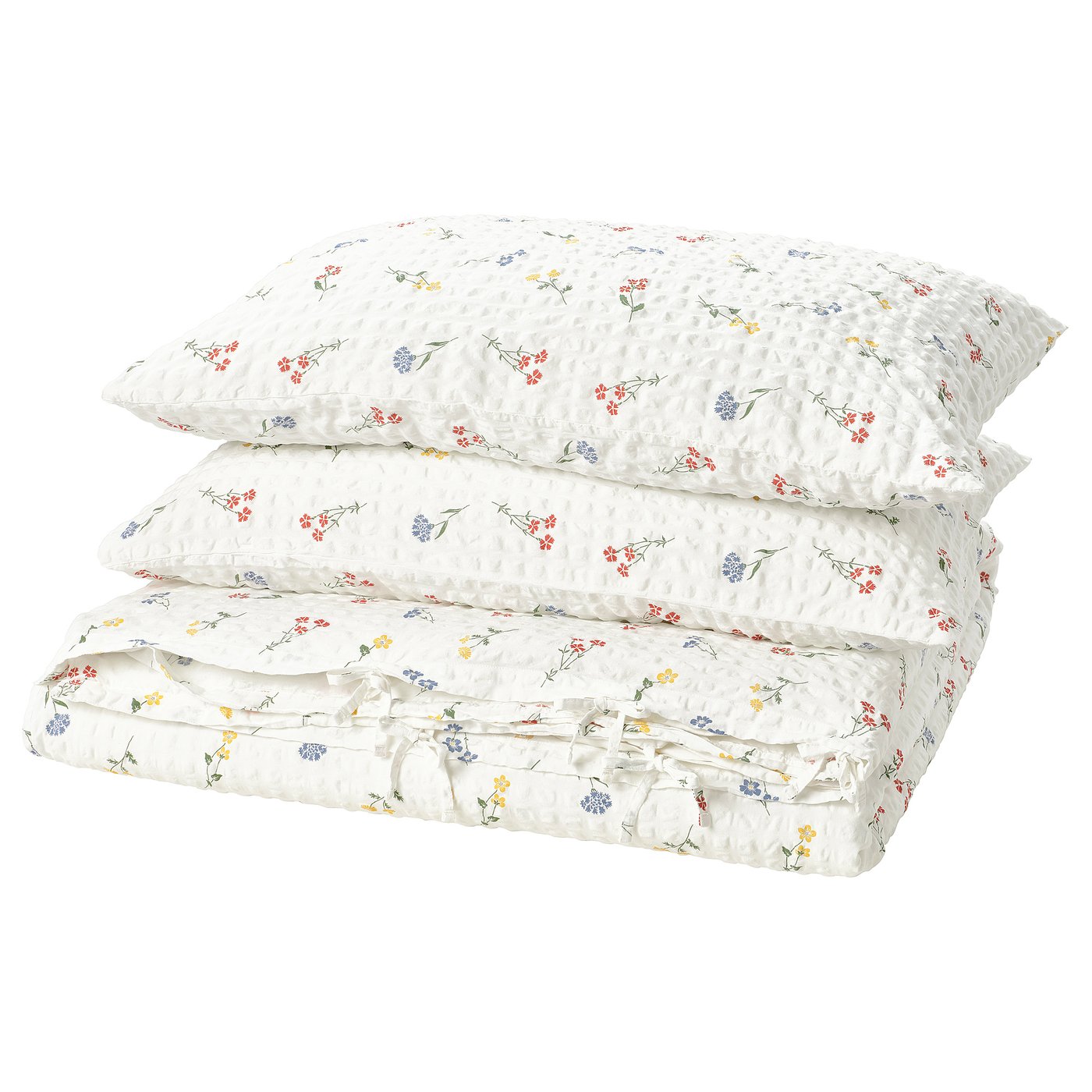 Floral bedding set, white with multi-colored flowers, folded neatly featuring a textured seersucker surface.