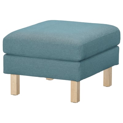 Blue cushioned footstool, wooden legs, recycled materials, square shape.