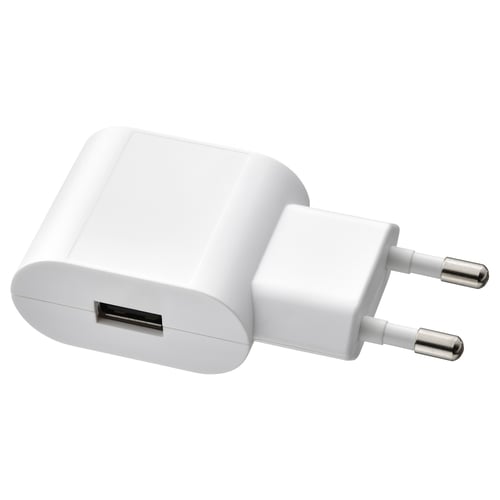 Small white usb charger, compact, rounded edges, metallic prongs, suitable for smartphones and led spotlights.