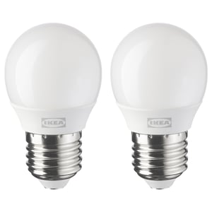Two identical ikea led light bulbs, white, round shape with e26 base, stand side by side.