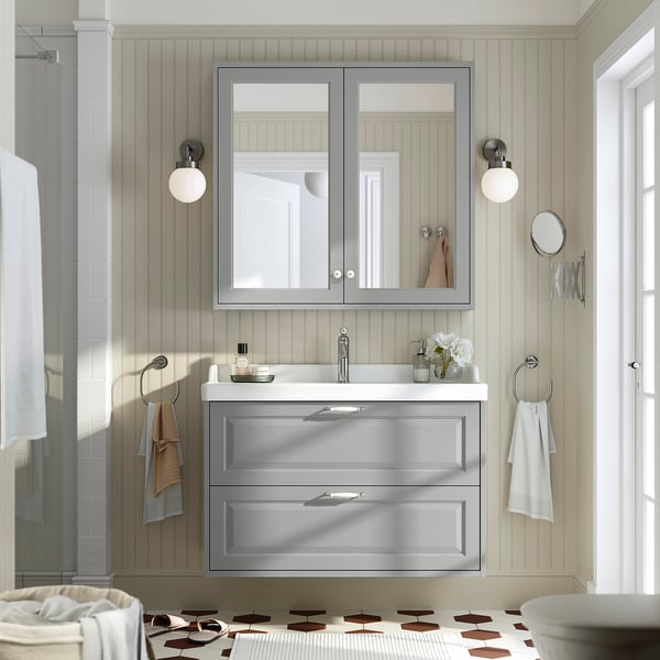Grey bathroom vanity with sink, wall-mounted.