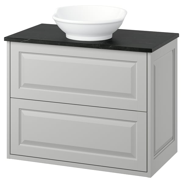 Elegant light grey TÄNNFORSEN bathroom vanity with a round white sink on a black countertop. Classic, craftsman design.