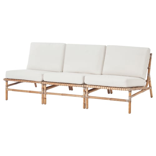 White outdoor sofa with woven rattan frame and cushions.