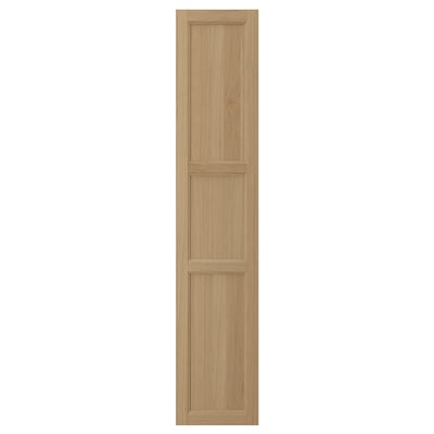 A tall, rectangular wooden door in natural oak with three rectangular panels. It a classic, simple design with a solid oak frame and veneer panelling.